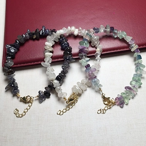 Detailed macro of crystal chip bracelets with adjustable gold clasps and extendable chains