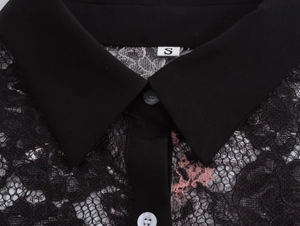 Detail view of lace shirt showing size S label, white buttons, and pink embroidery pattern