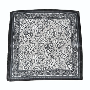Detail shot of black and white paisley pattern square scarf with decorative borders