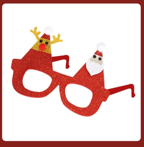 Detail of red glitter Christmas glasses with Santa and reindeer party decorations