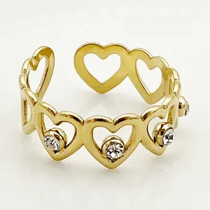 Close-up of gold plated heart chain ring with sparkling zircon and adjustable open band