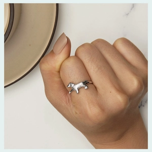 Detailed close-up of a 925 sterling silver golden retriever dog open ring worn on finger