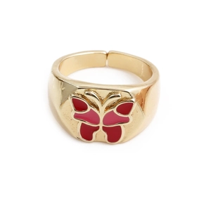 Detail of a gold butterfly ring featuring vibrant red and pink enamel wing fillings