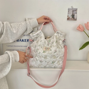 Close-up of quilted cotton tote bag with cartoon rabbit prints and pink shoulder strap