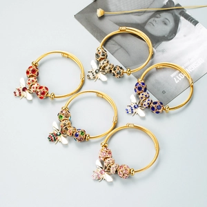 Detailed view of five gold-plated bee bracelets with colorful crystal bead charms