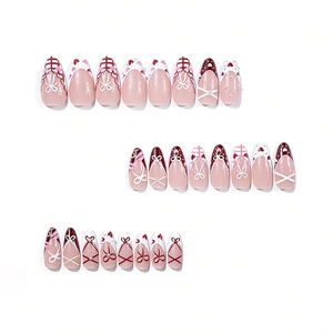 Pink and burgundy long almond press-on nails with bow designs and pearl accents