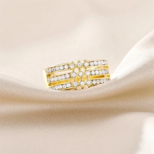Detail of gold titanium ring with three rows of pavé zircons and diamond-shaped centerpiece