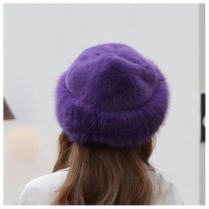 Close-up of deep purple faux fur winter hat showing thick plush texture and stylish dome shape