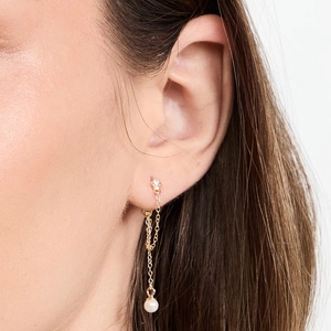Detailed close-up of a silver chain tassel earring with pearl and cubic zirconia