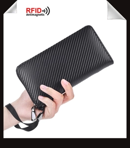 Close-up of black carbon fiber texture wallet with RFID protection and wrist strap