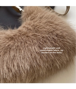 Detail of soft brown faux fur texture and dark leather strap on plush shoulder bag