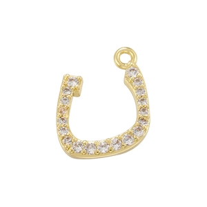 Detailed view of horseshoe pendant with gold plating and sparkling cubic zirconia stones