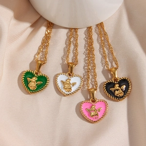 Golden heart necklaces with angel cherub pendants in green, white, pink, and black enamel