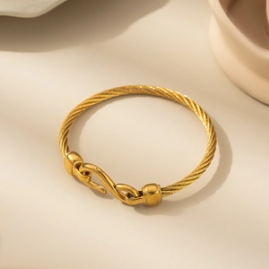 Minimalist gold stainless steel cable bracelet with unique S-hook clasp and woven design
