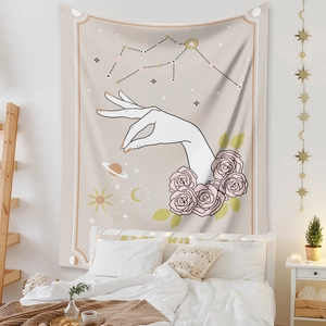 Close-up of bohemian tapestry with sun, moon, and floral motifs as a bedroom backdrop
