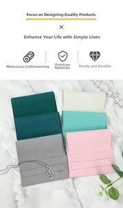 Detailed view of microfiber velvet jewelry pouches in five muted colors on marble