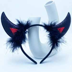 Detail of black glitter devil horns headband with faux feathers for Halloween costume