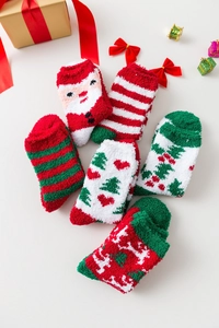 Flat lay of warm Christmas coral fleece socks with festive reindeer and Santa patterns