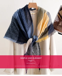 Detail of colorful plaid cashmere shawl scarf with fringes on a wooden hanger