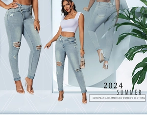 Detail of high waist ripped jeans with asymmetrical waistband and distressed denim texture