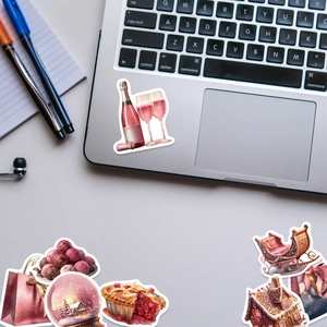 Christmas stickers featuring festive icons applied on a silver laptop for decoration
