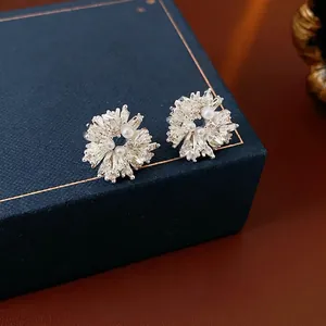 Flower crystal and pearl earrings with silver base on a premium jewelry box