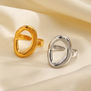 Minimalist irregular oval open rings in polished gold and silver on silk background