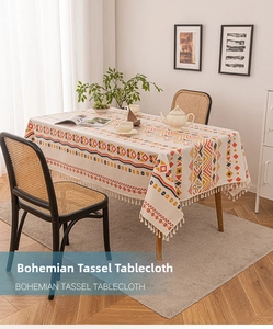 Detailed view of bohemian linen tablecloth with geometric patterns and fringe tassels
