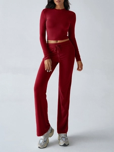 Detail view of burgundy Y2K style long sleeve crop top and matching baggy trousers set