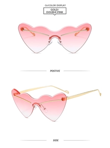 Detail of rimless heart-shaped sunglasses with gold metal frame and pink gradient lenses
