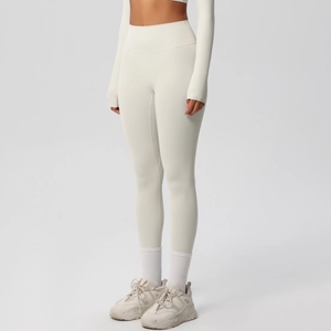 Close-up of high-waisted seamless yoga leggings in ivory white with premium fabric texture