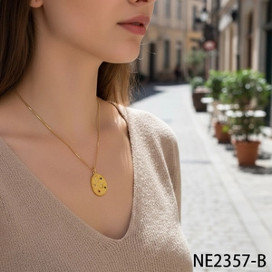 Detail of gold star and moon pendant with colorful zircon stones on a fine link chain