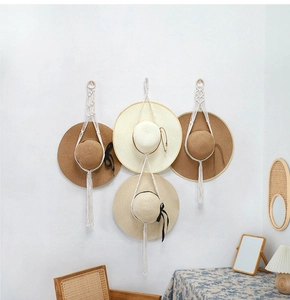 Detail of bohemian macrame hat hanger with handcrafted cotton rope weaving and tassels