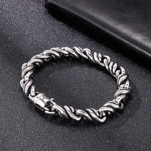 Close-up of twisted link design on silver titanium steel bracelet for men