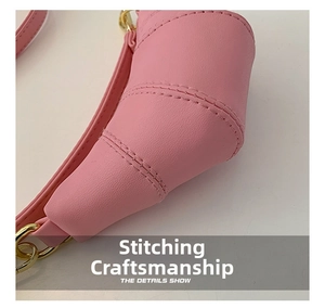 Detail shot of parallel stitching on the pink crescent bag with metal chain accents