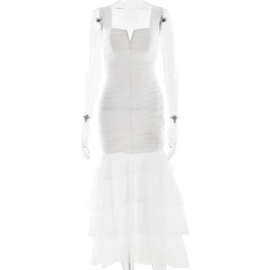 Detail of ruched white bodycon dress featuring layered tulle fishtail hem and V-neckline