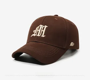 Close-up of brown cotton baseball cap with white embroidery and M sport detail