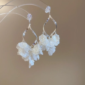 Detailed view of silver zircon pearl tassel earrings with cascading translucent petals