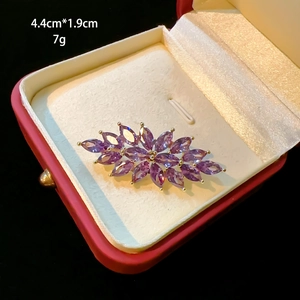 Detailed macro view of amethyst zircon brooch in a red gift box with dimensions 4.4x1.9cm