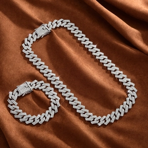 Macro shot of silver hip-hop Cuban link chain and bracelet with shiny rhinestones