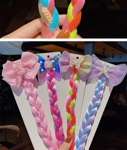 Detail of colorful bow hair clips with gradient hair extensions and pearl accents