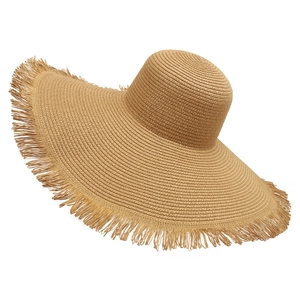 Detailed close-up of wide brim straw beach hat with natural frayed edges and weave texture