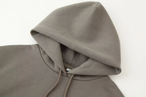 Detailed macro view of gray hoodie neckline with S size tag and soft cotton fabric texture