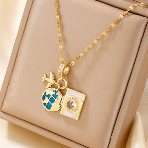 Elegant gold travel theme necklace with airplane and blue enamel globe pendant