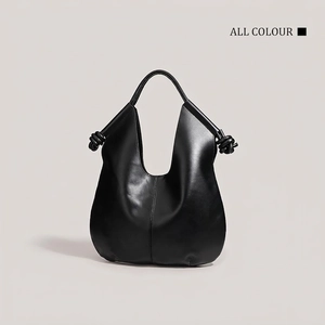 Minimalist black leather hobo tote bag with unique knot detail on handles and seam line