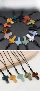Detailed view of woven cross necklaces in assorted natural crystals and agate stones