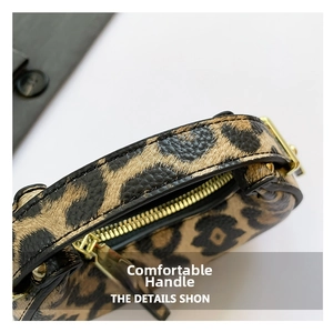 Close-up of leopard print handbag featuring textured leather and gold metal zipper