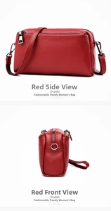 Detail view of red lychee grain leather crossbody bag with multiple silver zippers