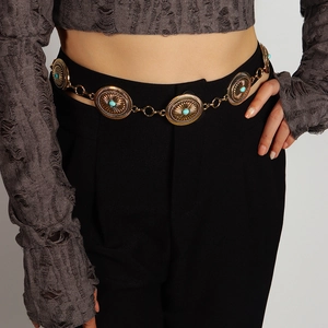 Detail of bohemian metal waist chain with vintage bronze discs and turquoise inlay