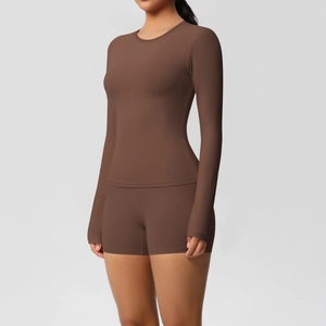 Detail of dark brown long-sleeve crop top and high-waist shorts seamless yoga set